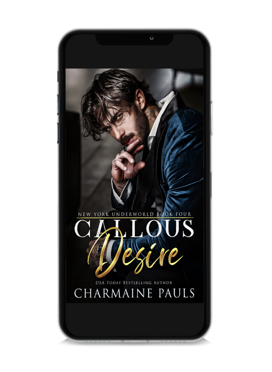 A cell phone displaying the book cover of 'Callous Desire' by Charmaine Pauls.